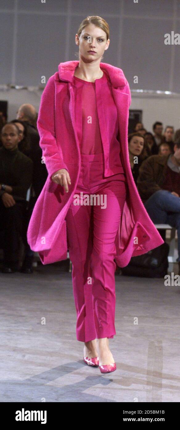 A model presents a pink blouse, jacket and pants with a matching pink fur-trimmed  jacket at a showing of the Helmut Lang Fall 2000 line in New York, February  10. Designers are