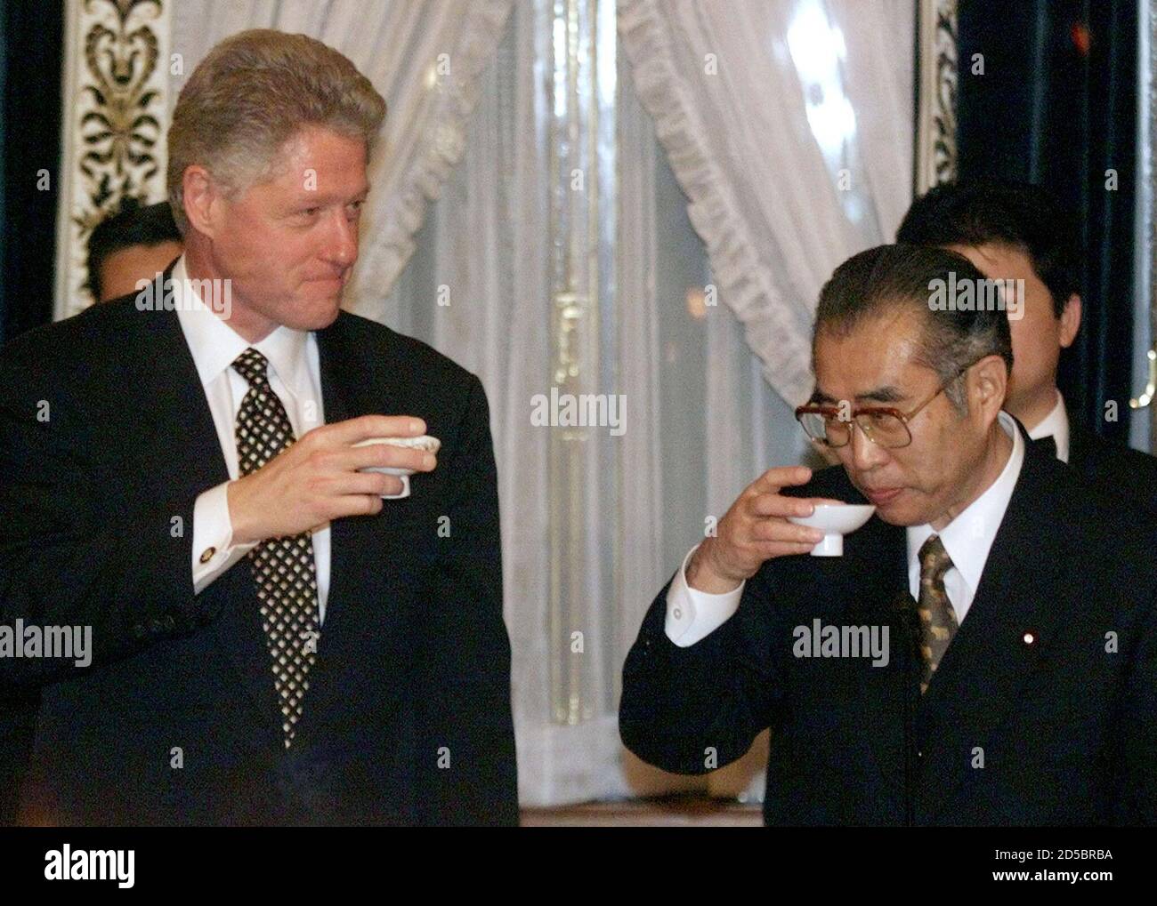 U.S. President Bill Clinton toasts Japanese Prime Minister Keizo Obuchi at  the start of a dinner at the Akasaka Palace in Tokyo November 19. The  president praised the close ties between the