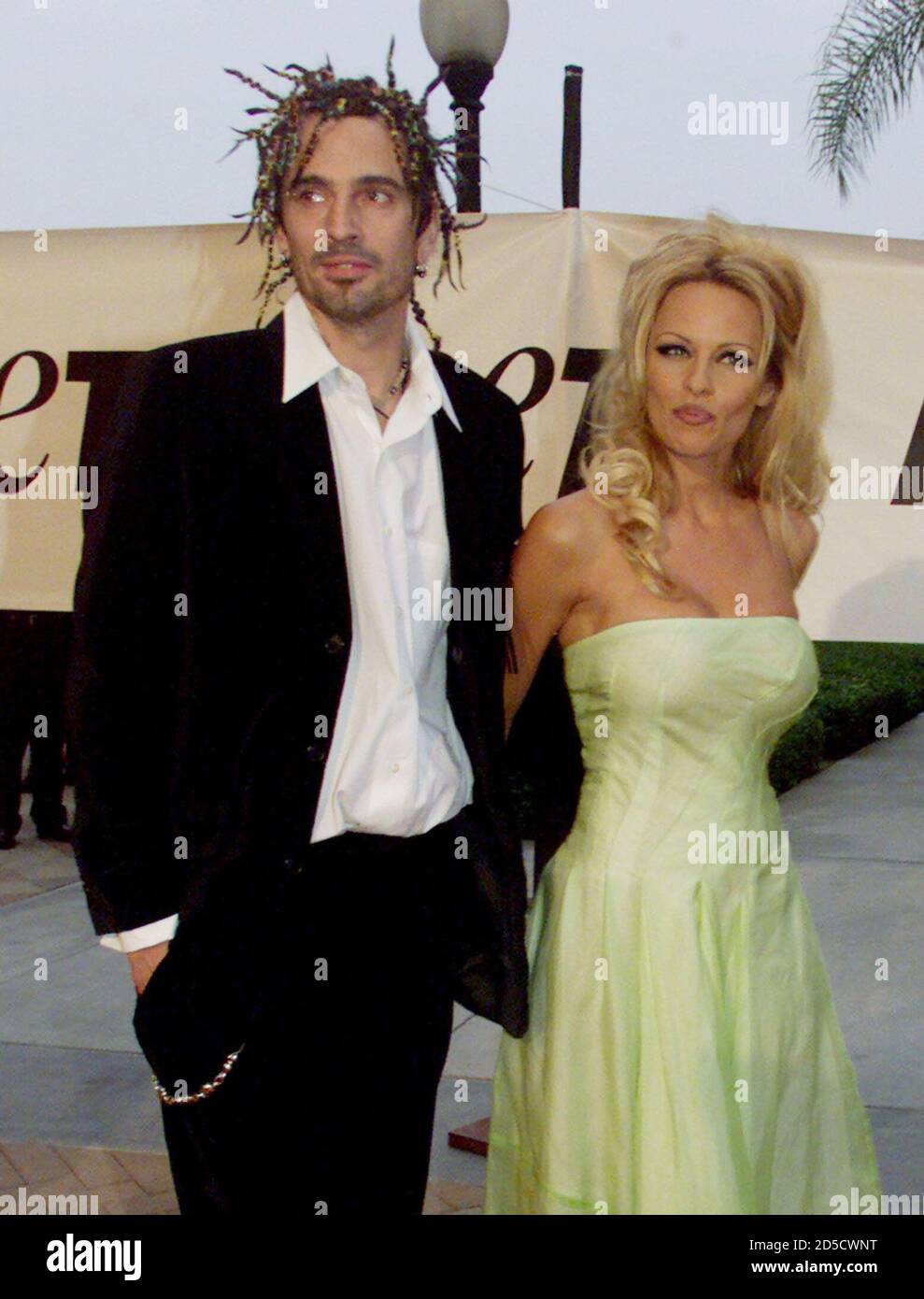 Actress Pamela Anderson Lee and former husband and current companion  musician Tommy Lee pose as they arrive for the People for the Ethical  Treatment of Animals Party of the Century and Humanitarian