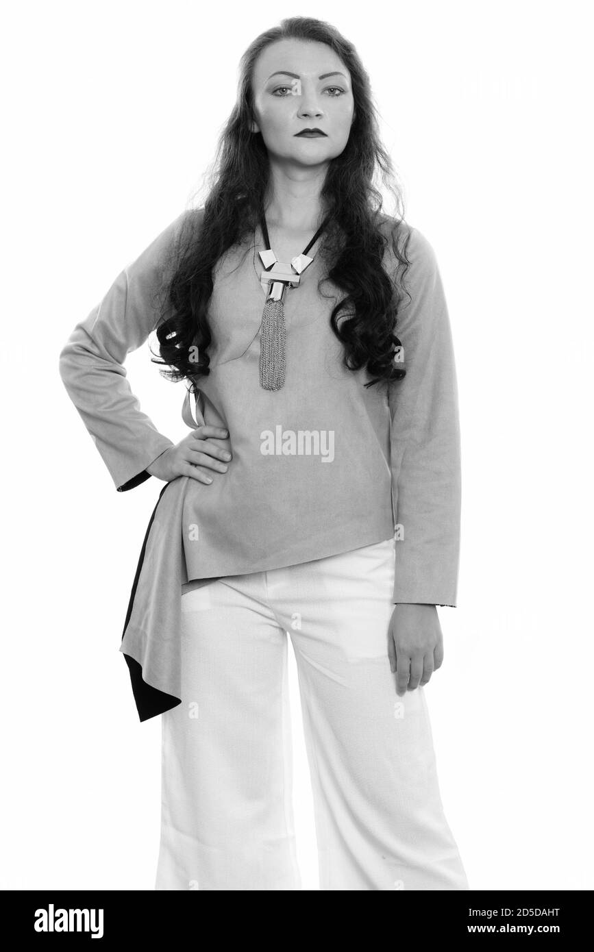 Studio shot of woman standing with hand on hip Banque D'Images
