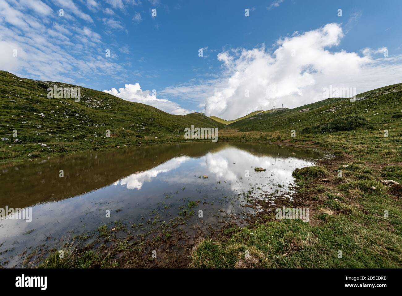 Monte Baldo (montagne Baldo), crête de Naole. Chaîne de montagnes entre le lac de Garde et la vallée de l'Adige. Prés verts et petit étang pour les vaches. Vérone, Italie. Banque D'Images