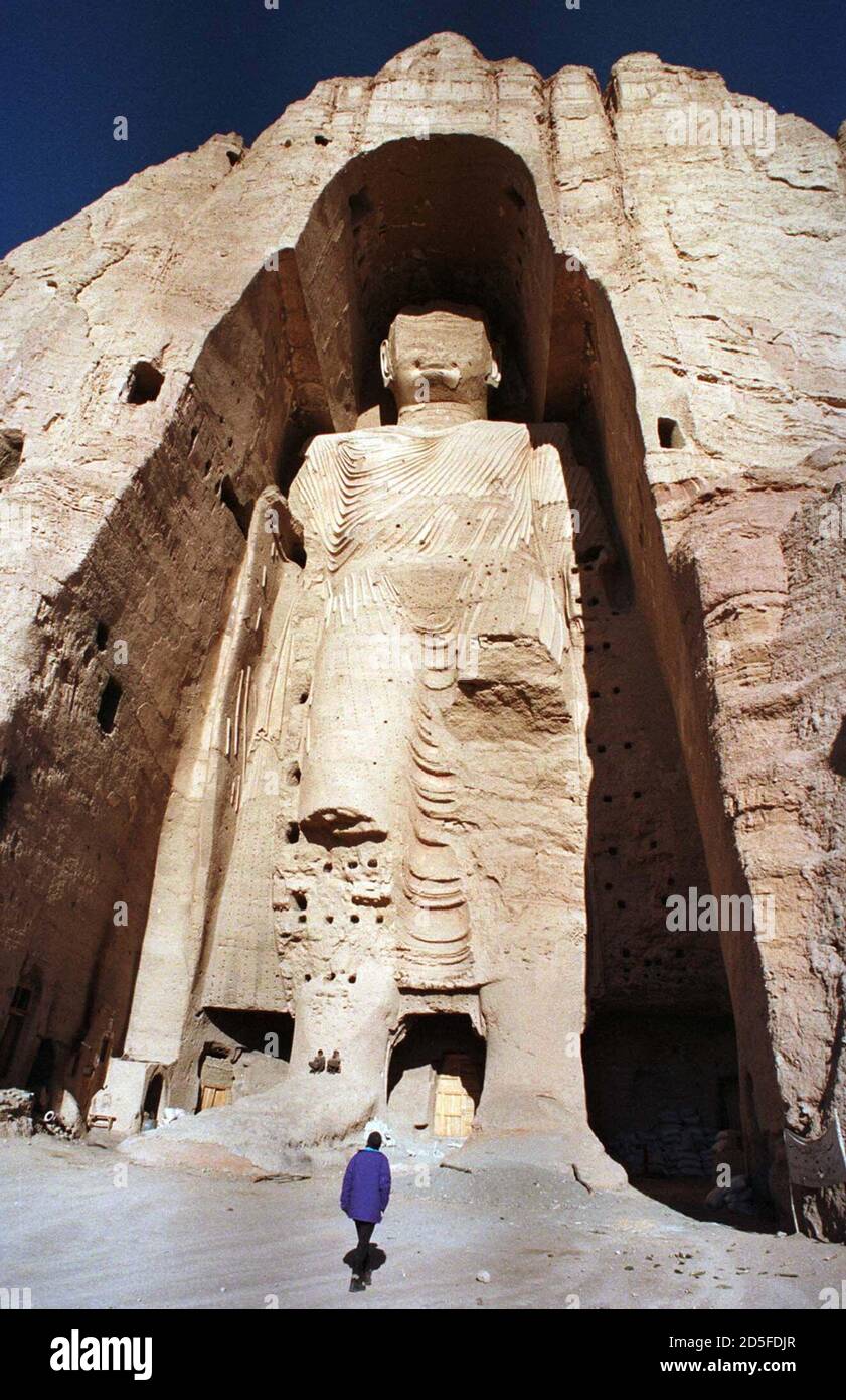 A visitor walks past the 55metrehigh Buddha statue in the Bamiyan