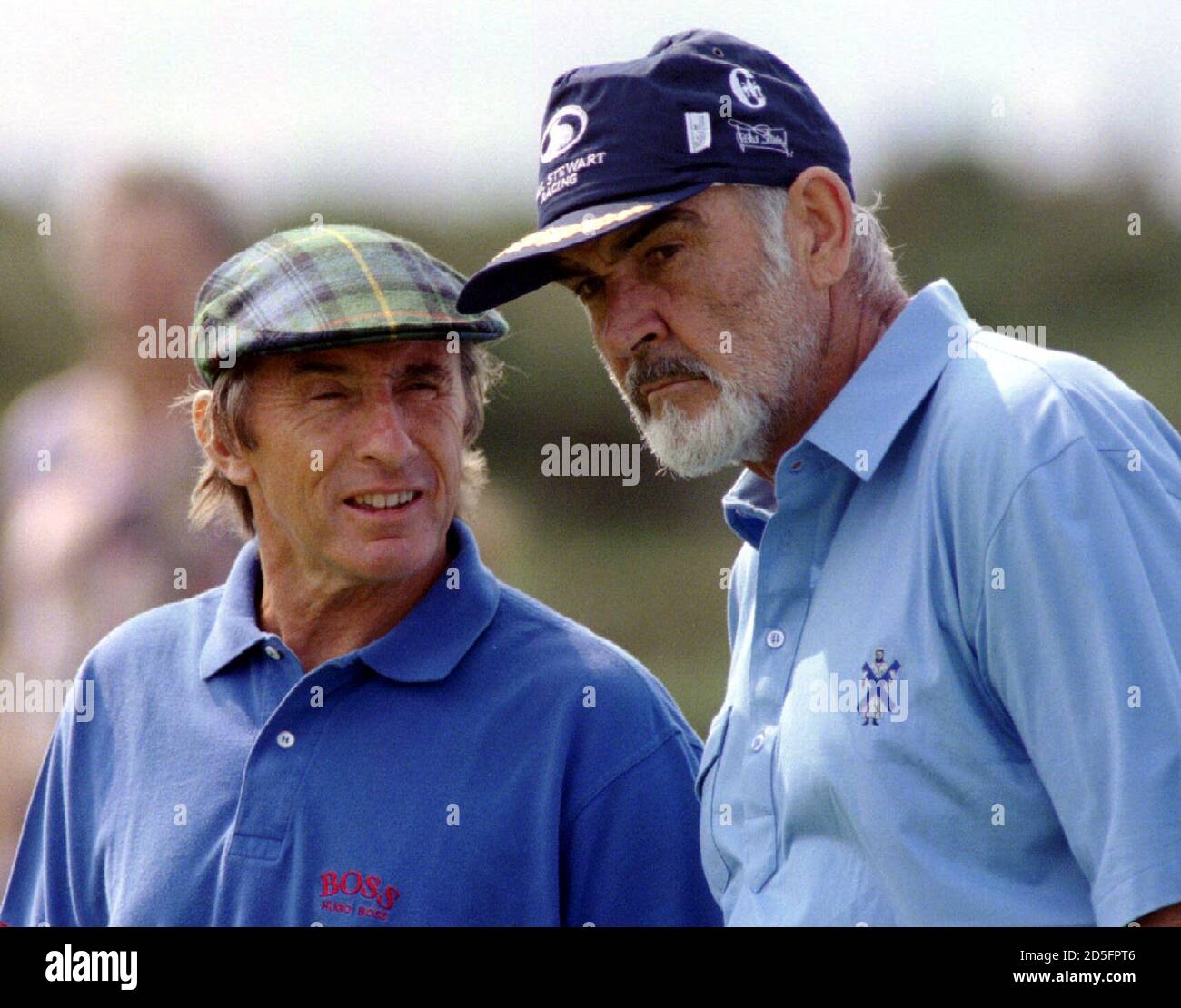 Former James Bond Sean Connery (right) gets some advice from team mate and  former Formula One world champion Jackie Stewart on the 2nd green at  Prestwick Golf course August 7 Photo Stock -