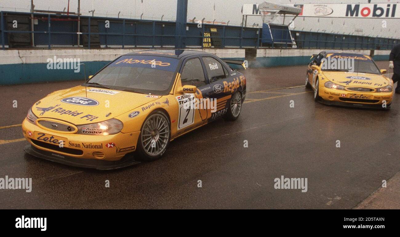 Anthony Reid, pilote de Ford Mondeo, dirige son coéquipier Alain Menu Dehors pour la pratique pour le tour d'ouverture des Britanniques Championnat de voitures de tourisme à Donington Park Banque D'Images