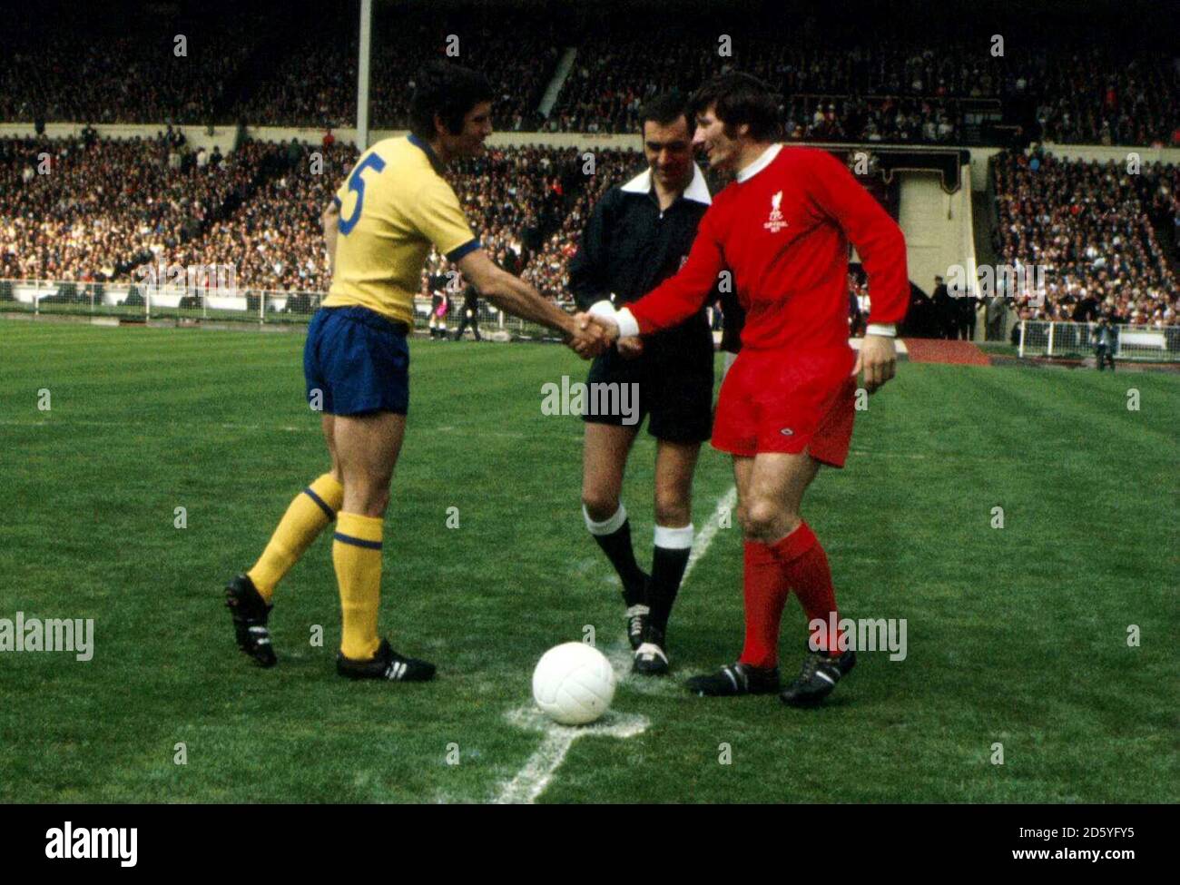 le capitaine de l-r Arsenal Frank McLintock (l) serre la main avec celle de Liverpool Tommy Smith (r) comme l'arbitre Norman Burtenshaw regarde Banque D'Images