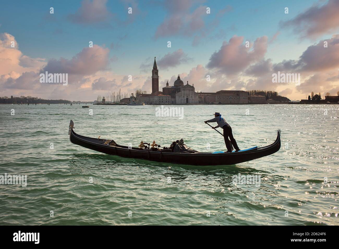 Gondolier ramer sur la lagune de Venise avec l'église de San Giorgio Maggiore en arrière-plan, Venise, Italie Banque D'Images