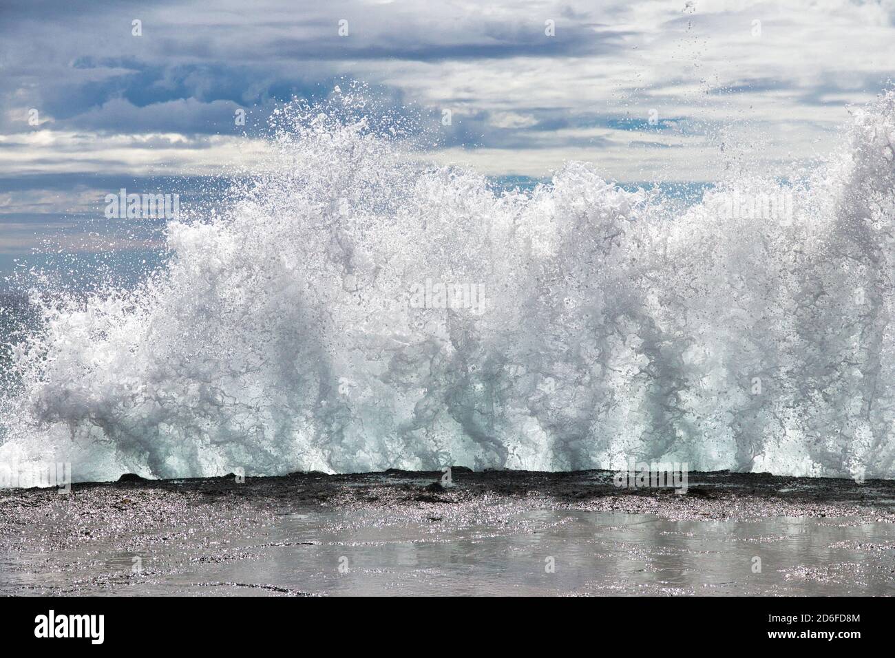 Une énorme vague s'est déferlante contre le quai d'Olawalu Landing à Maui. Banque D'Images