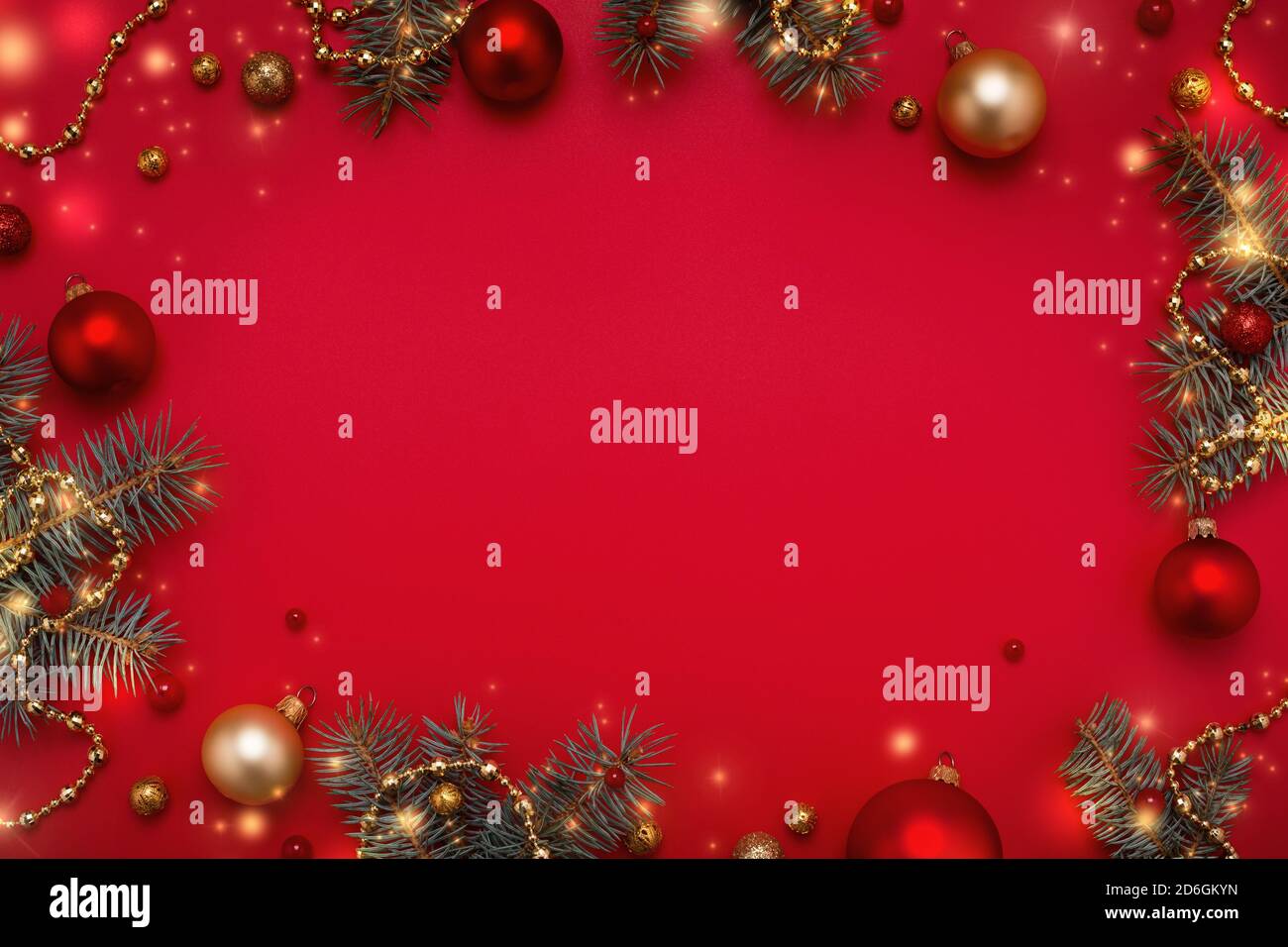 Cadre de Noël de guirlande de sapin, décorations dorées sur fond rouge de l'espace de copie. Banque D'Images
