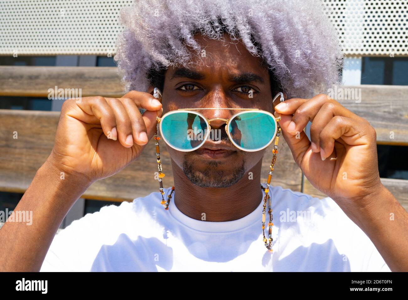 Homme noir avec cheveux afro mettant sur des lunettes de soleil. Lunettes  de soleil et concept afro Photo Stock - Alamy