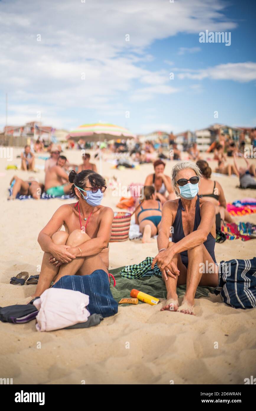 Femmes portant un masque de protection respiratoire sur la plage, France, août 2020. Banque D'Images