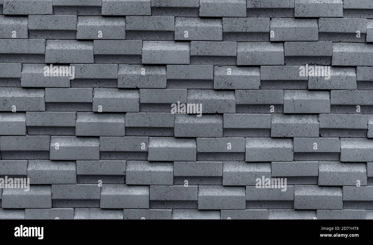 Mur en brique grise avec motif simple. Fond abstrait de texture de paroi grise. Design moderne de fond de mur de briques. Papier peint abstrait simple. Banque D'Images