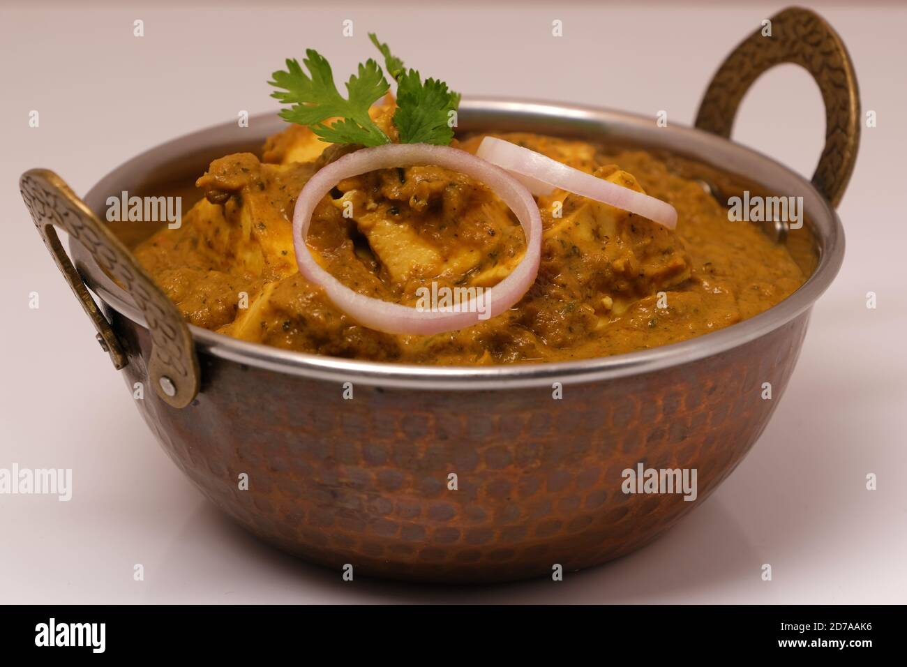 La nourriture indienne ou indien Curry dans un cuivre laiton bol de service. Banque D'Images
