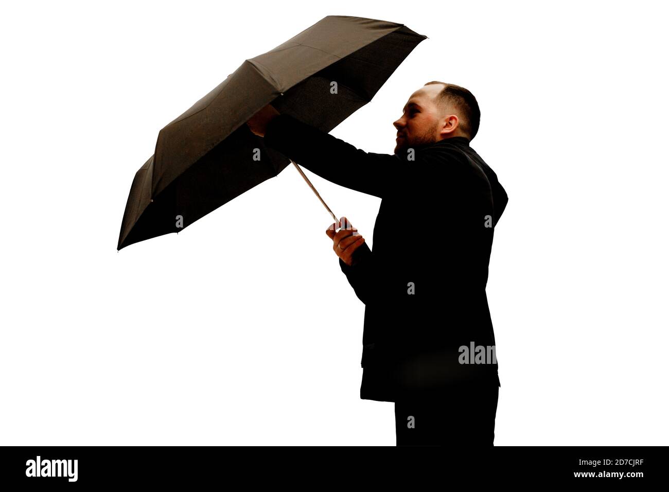 Homme avec parapluie en studio Banque D'Images