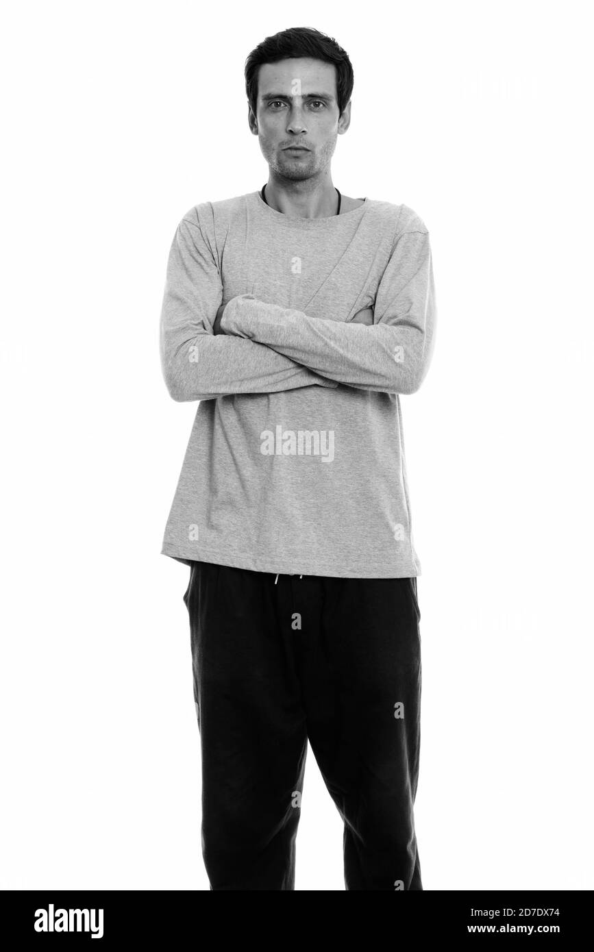 Studio shot of young man standing with arms crossed Banque D'Images Studio shot of young man standing with arms crossed Banque D'Images