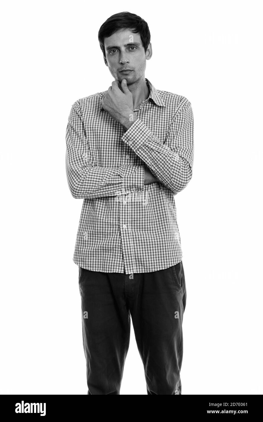 Studio shot of young handsome businessman standing en pensant Banque D'Images Studio shot of young handsome businessman standing en pensant Banque D'Images