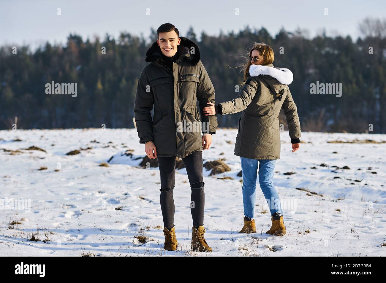 Heureux couple hugging and laughing outdoors in winter Banque D'Images