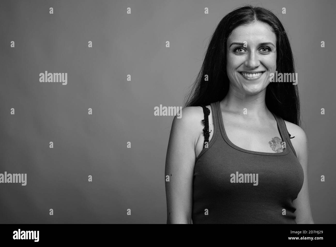 Belle jeune femme contre l'arrière-plan gris Banque D'Images