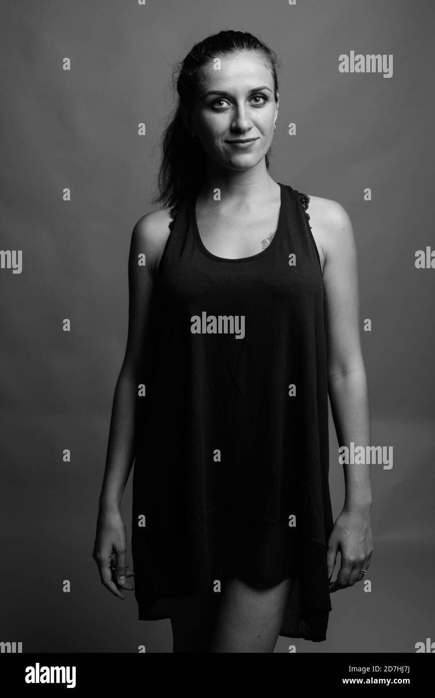 Belle jeune femme contre l'arrière-plan gris Banque D'Images