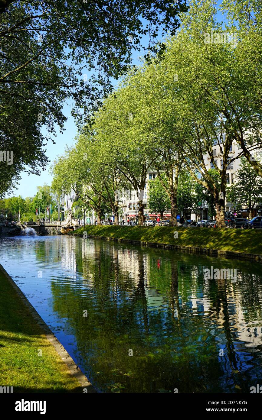 Le magnifique canal vert de la ville 'Kö-Graben' sur Königsallee à Düsseldorf, un morceau de nature au milieu de la zone commerçante animée. Banque D'Images