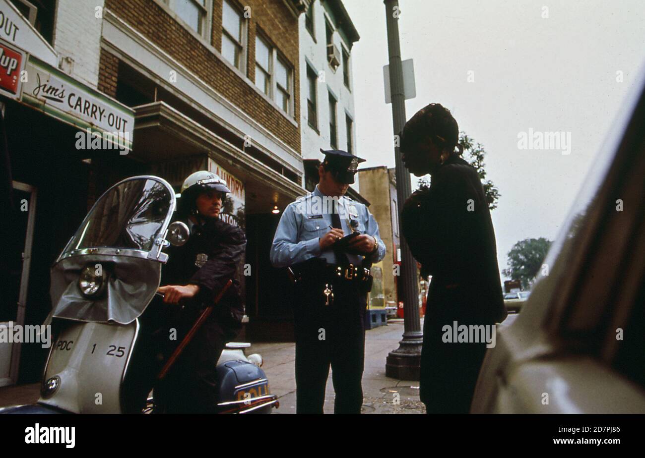 L'officier rédigeant un rapport sur une perturbation régulière de la paix (Washington D.C.) ca. 1973 Banque D'Images