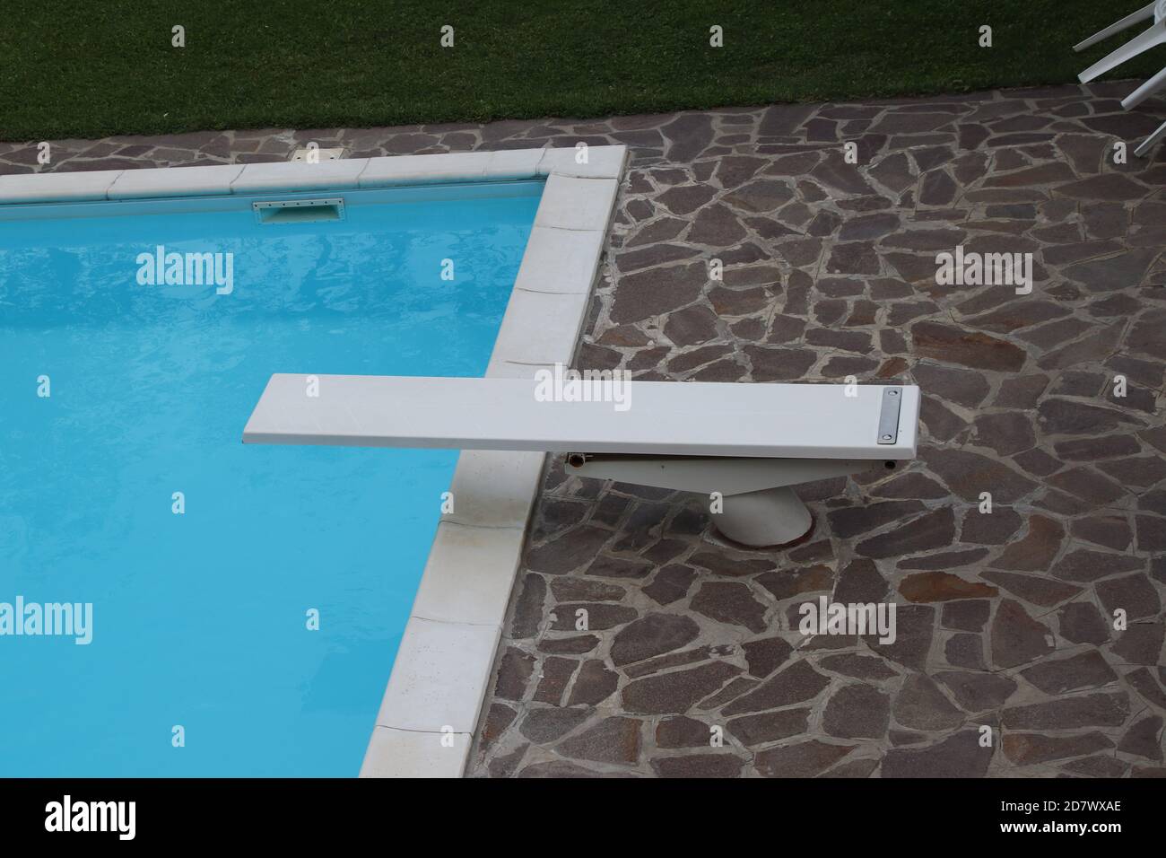 Tremplin à la piscine. Il s'agit d'une carte solide et flexible à partir de laquelle quelqu'un peut sauter afin de gagner de l'élan supplémentaire lors de l'exécution d'un plongeon sur Banque D'Images
