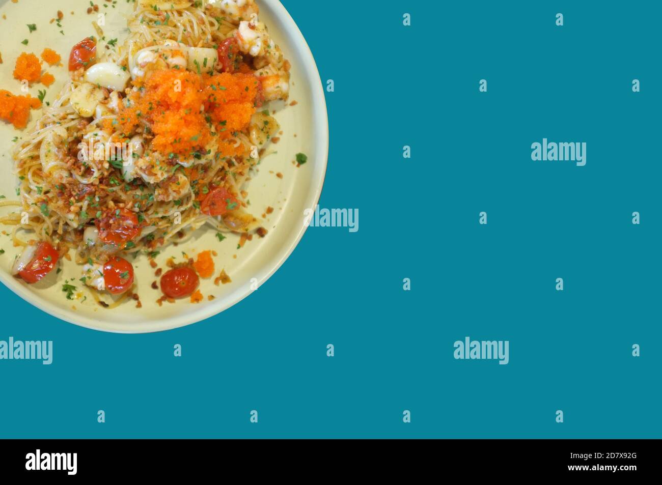 Fusion de style alimentaire, sauce à la crème spaghetti crevettes aux oeufs sur fond bleu Banque D'Images