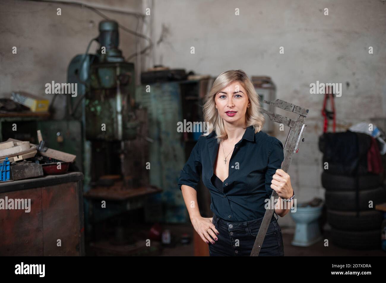 Portrait d'une belle jeune femme blonde avec des yeux bleus avec des machines anciennes Banque D'Images