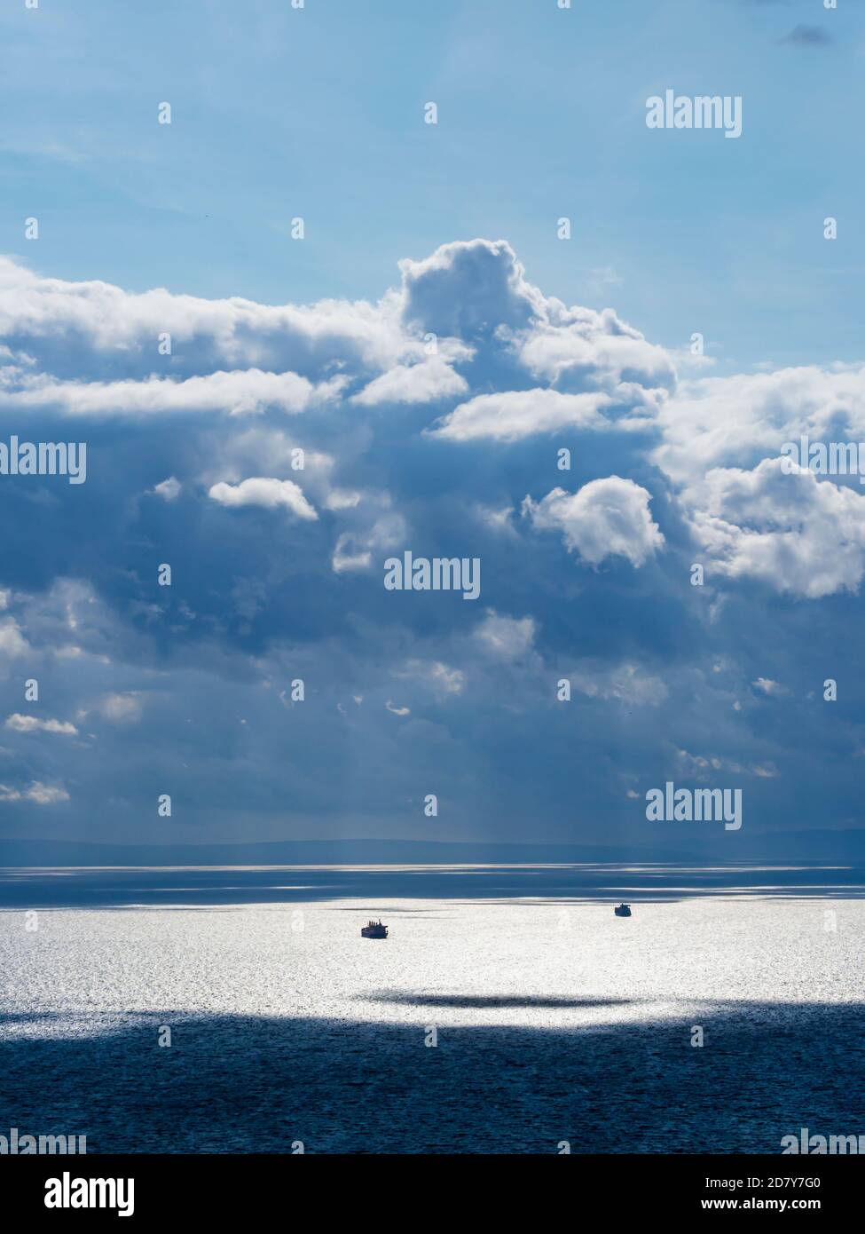 Paysage marin spectaculaire et magnifique, nuages boursouflés et plusieurs silhouetements de navires contre l'horizon forte lumière du soleil lumière du soleil reflet de la surface de la mer Banque D'Images