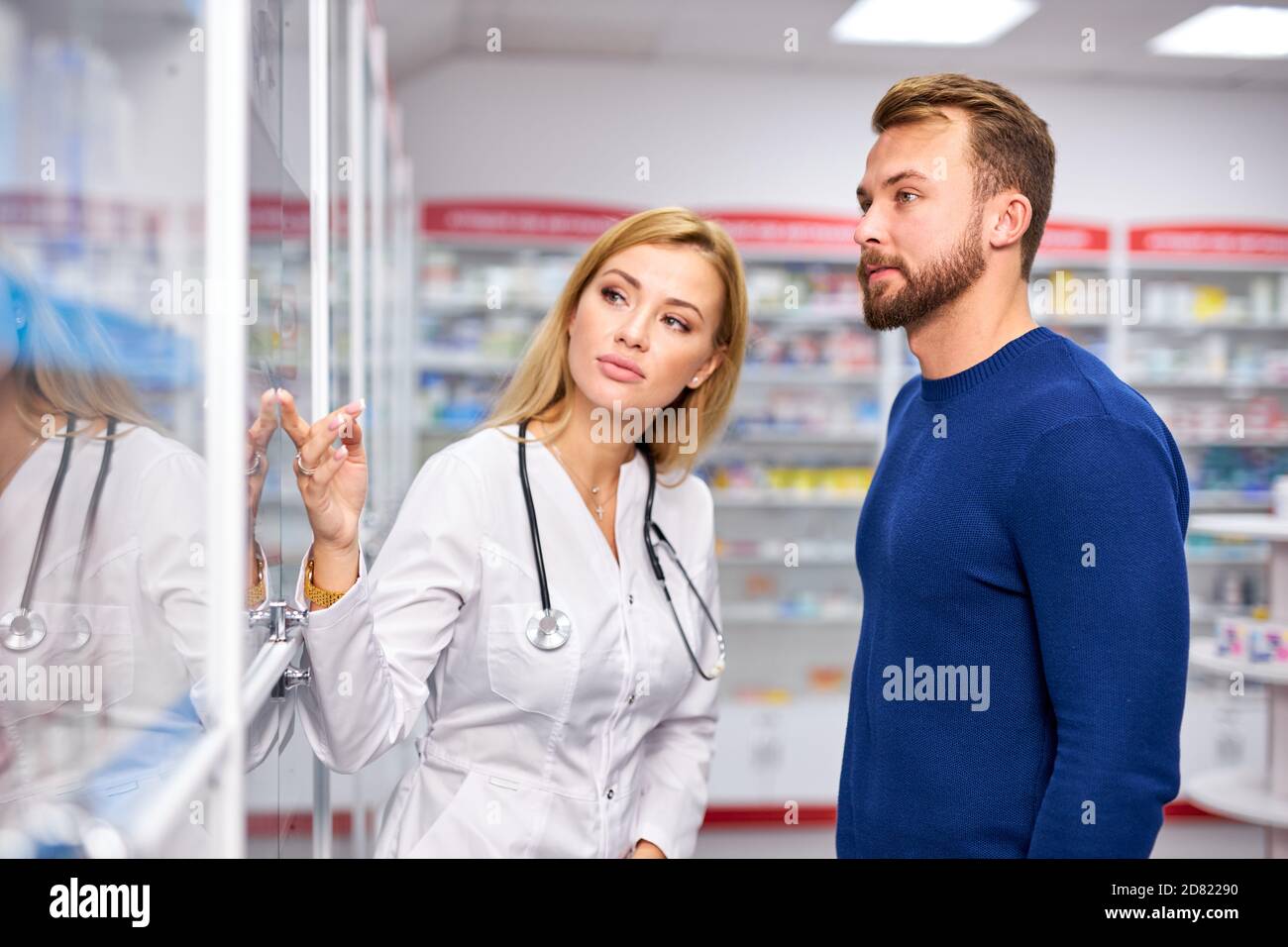 jeune femme pharmacien aidant malade homme client choisir des médicaments d'ordonnance de l'étagère, shopping à la pharmacie, prenant des conseils de chimiste professionnel. consumérisme, sympathique concept de personnel Banque D'Images