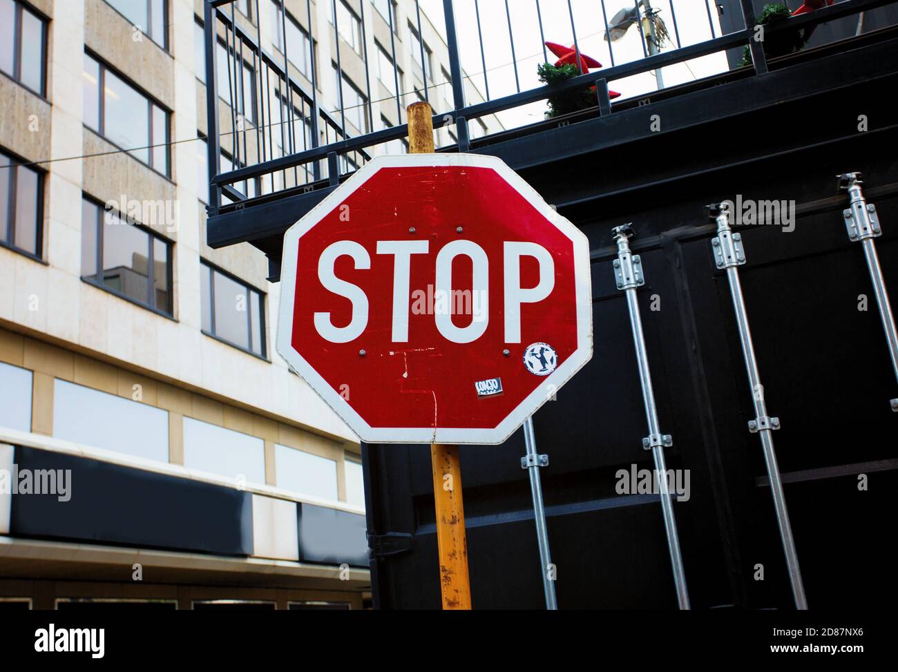 Signe rouge avec le mot anglais écrit Stop sur fond urbain Banque D'Images
