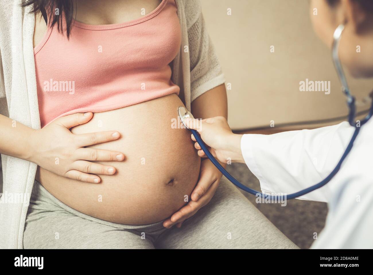 Bonne femme enceinte consulter un médecin gynécologue à l'hôpital ou à la clinique médicale pour un consultant en grossesse. Médecin examiner le ventre enceinte pour bébé et Banque D'Images