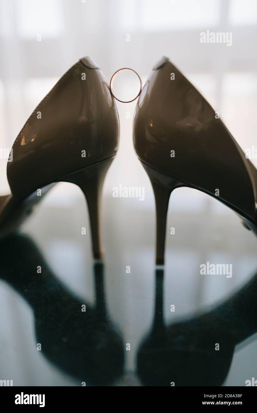 chaussures et anneaux de mariage sur table en verre Banque D'Images