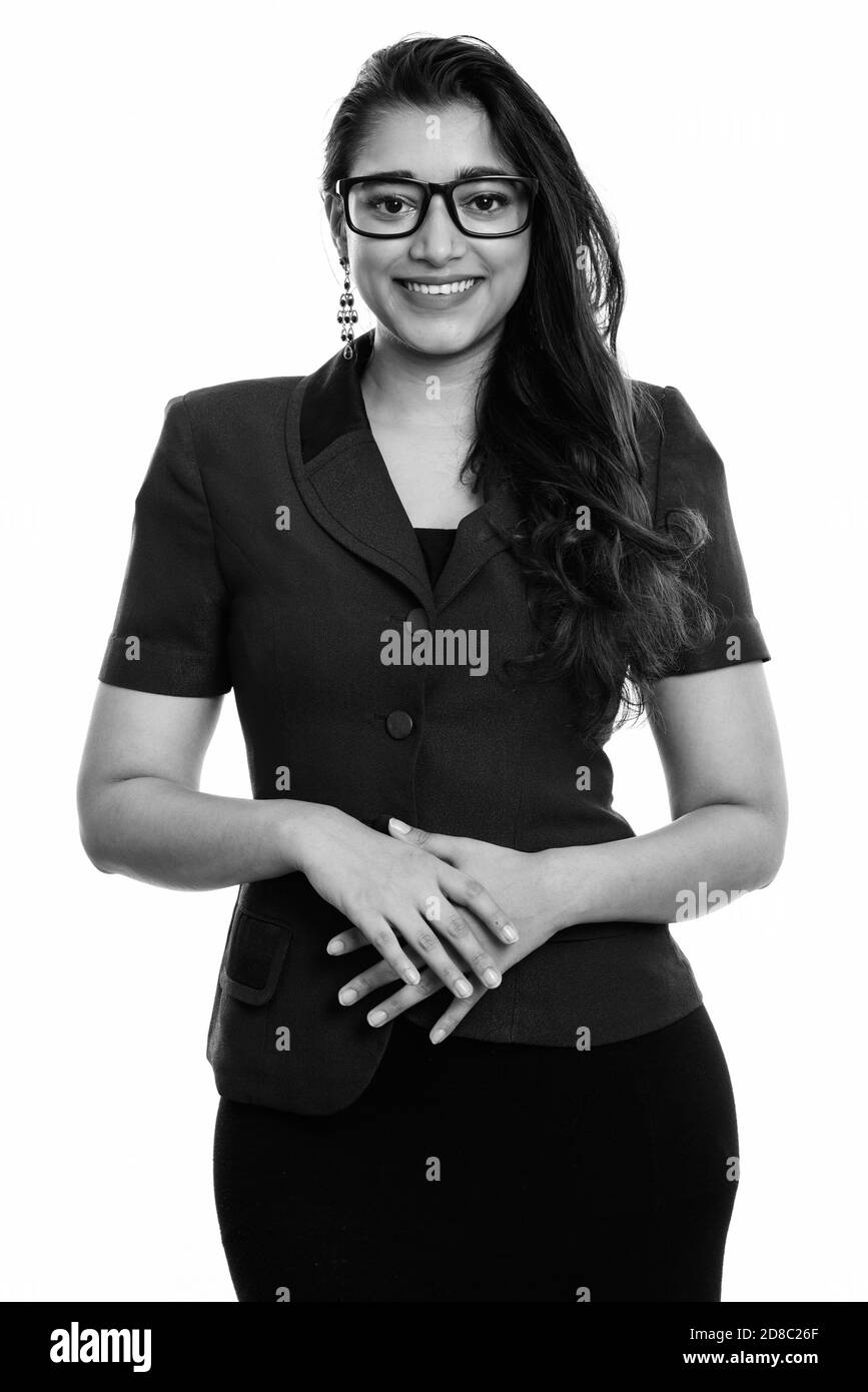 Studio shot of young happy Indian businesswoman smiling with hands together Banque D'Images