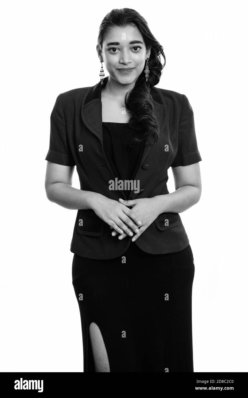 Studio shot of young beautiful Indian businesswoman standing with hands together Banque D'Images