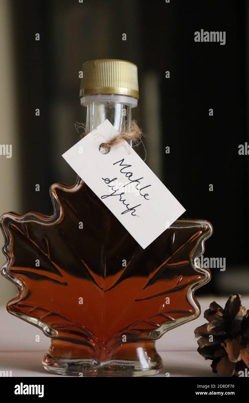 Sirop d'érable dans une bouteille en forme de feuille d'érable, avec étiquette manuscrite/Canada Banque D'Images