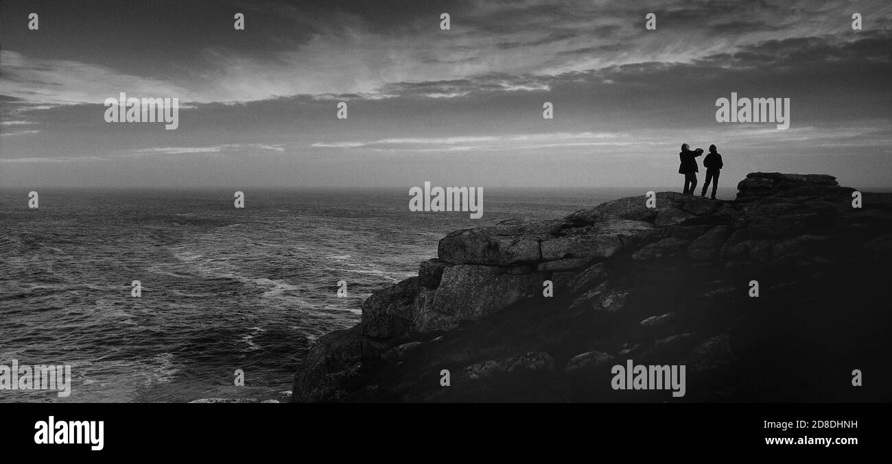 Un couple admirera la vue depuis la côte nord rocheuse de Tresco, îles de Scilly, Cornouailles, Angleterre, Royaume-Uni Banque D'Images