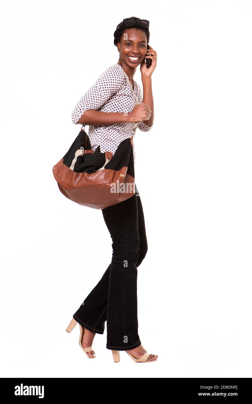 Portrait complet de la belle femme afro-américaine avec sac à main parler au téléphone Banque D'Images