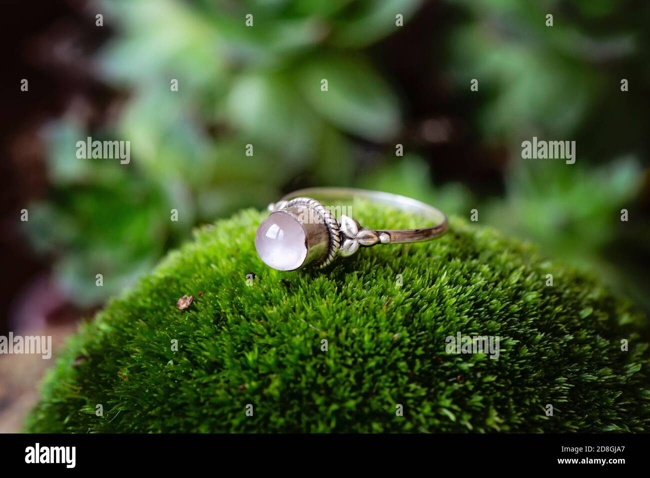 Bague en argent sterling avec pierre précieuse en quartz rose sur mousse  verte arrière-plan Photo Stock - Alamy