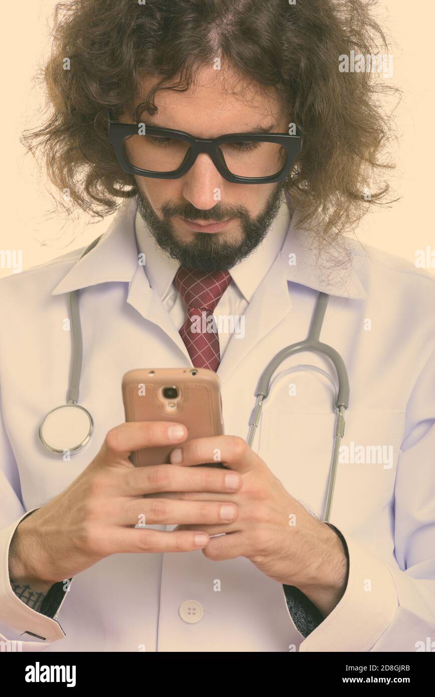 Studio shot of handsome man using mobile phone Banque D'Images