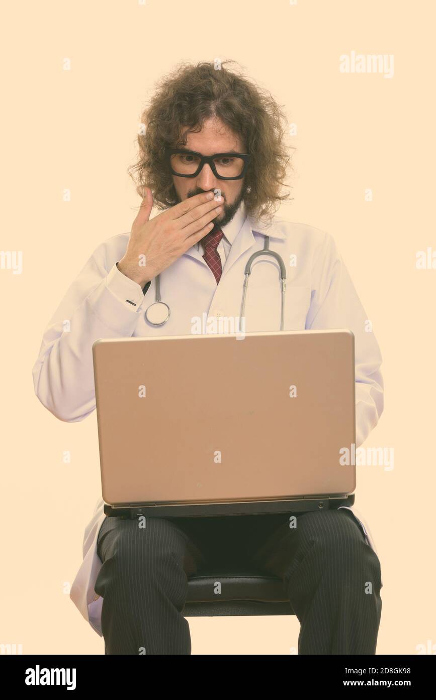 Studio shot of handsome man using laptop à choqué Banque D'Images