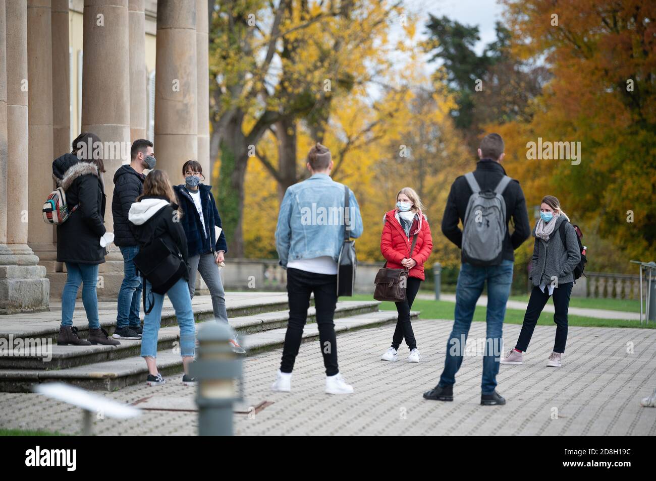 29 octobre 2020, Bade-Wurtemberg, Stuttgart : les étudiants de leur premier semestre se tiennent devant le château de Hohenheim, qui appartient à l'université de Hohenheim, lors d'une visite guidée du campus. Le semestre d'hiver 2020/2021 commence à Baden-Württemberg le 2 novembre dans des conditions d'hygiène plus strictes en raison de la pandémie du coronavirus. Photo: Sebastian Gollnow/dpa Banque D'Images