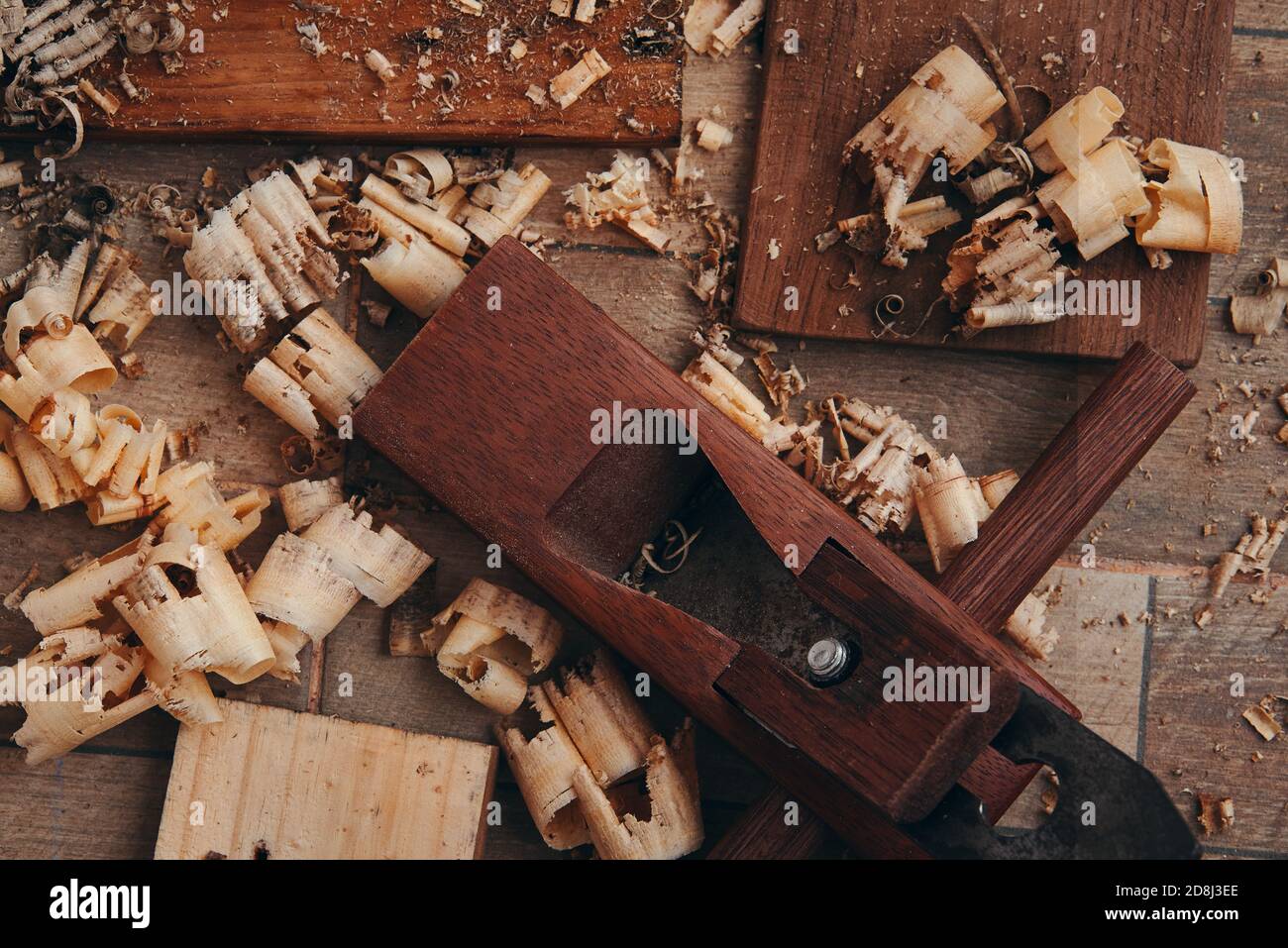 Une raboteuse à main et des copeaux de bois sur le sol carrelé Banque D'Images