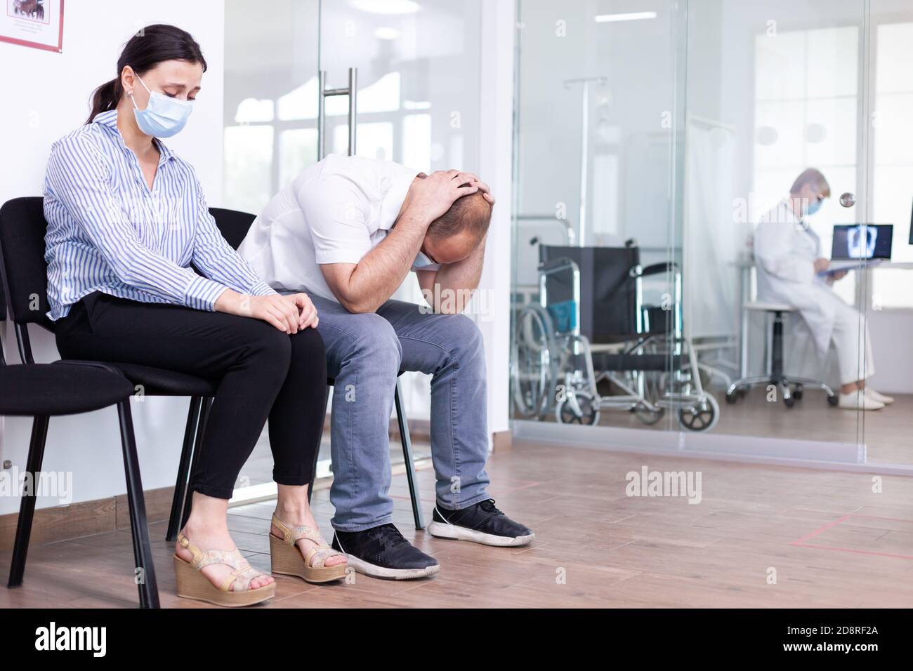 Homme et femme pleurant dans la salle d'attente de l'hôpital après de  mauvaises nouvelles du médecin. Le personnel médical donne des résultats de  test défavorables. Homme et femme stressés lors d'un rendez-vous