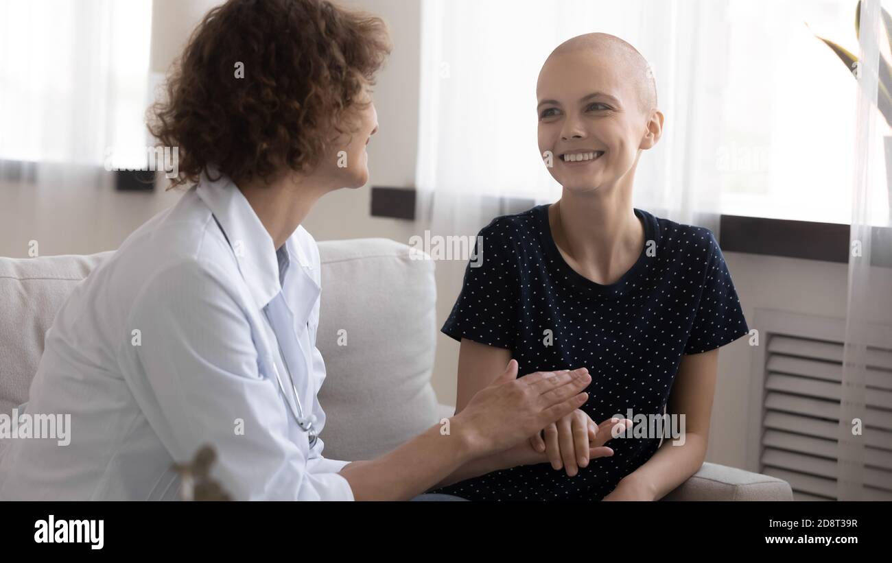 Gros plan médecin traitant tenant la main souriante de femme sans cheveux, en soutenant Banque D'Images