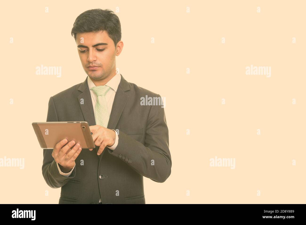 Young handsome Persian businessman using digital tablet Banque D'Images