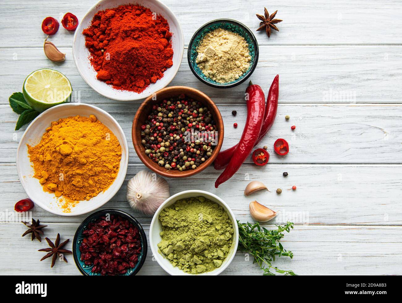 Différentes épices sur fond de bois blanc, vue sur le dessus Banque D'Images