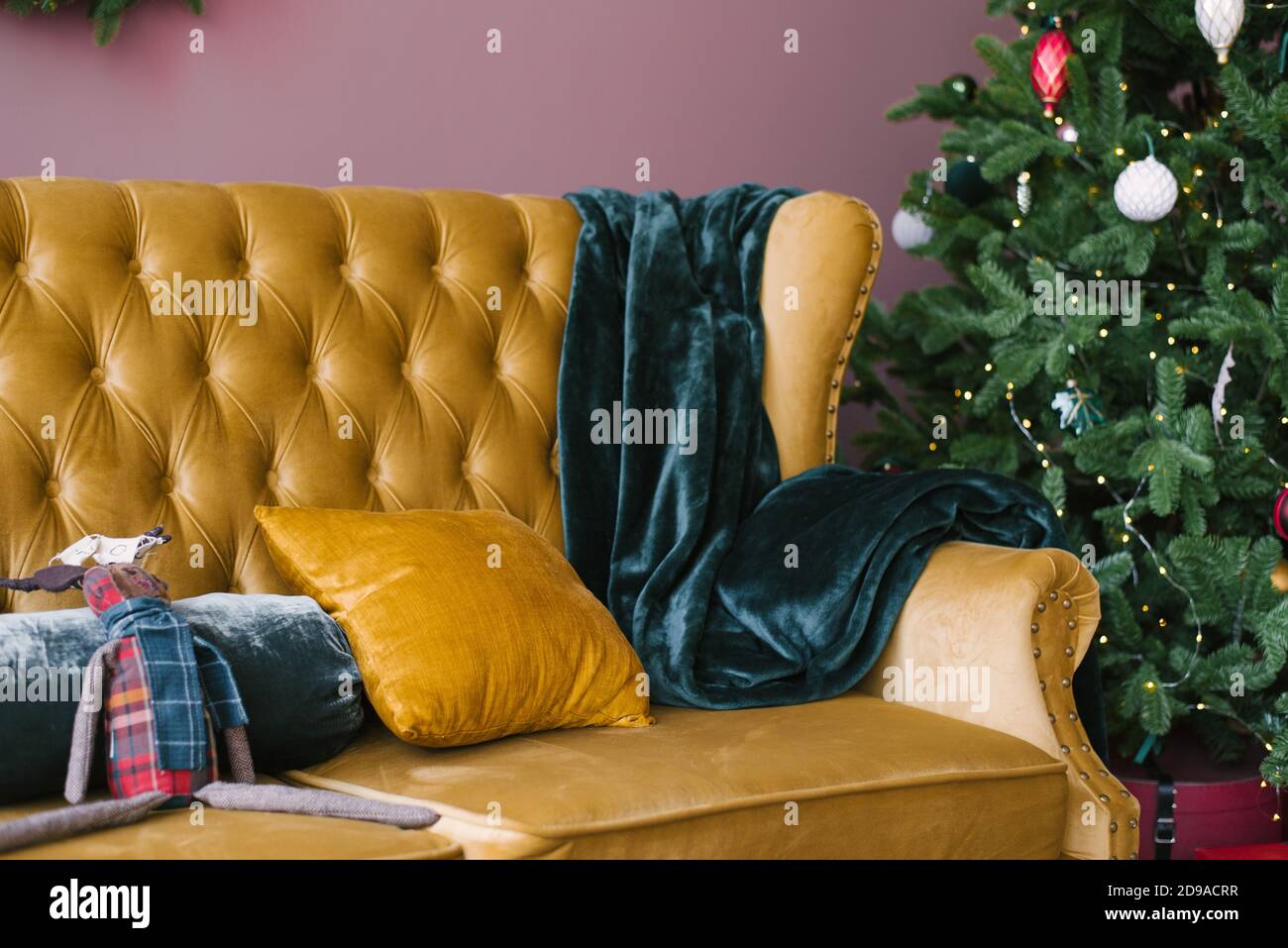 Un oreiller jaune et un motif écossais émeraude sur un jaune Canapé vintage  près de l'arbre de Noël dans le salon Photo Stock - Alamy