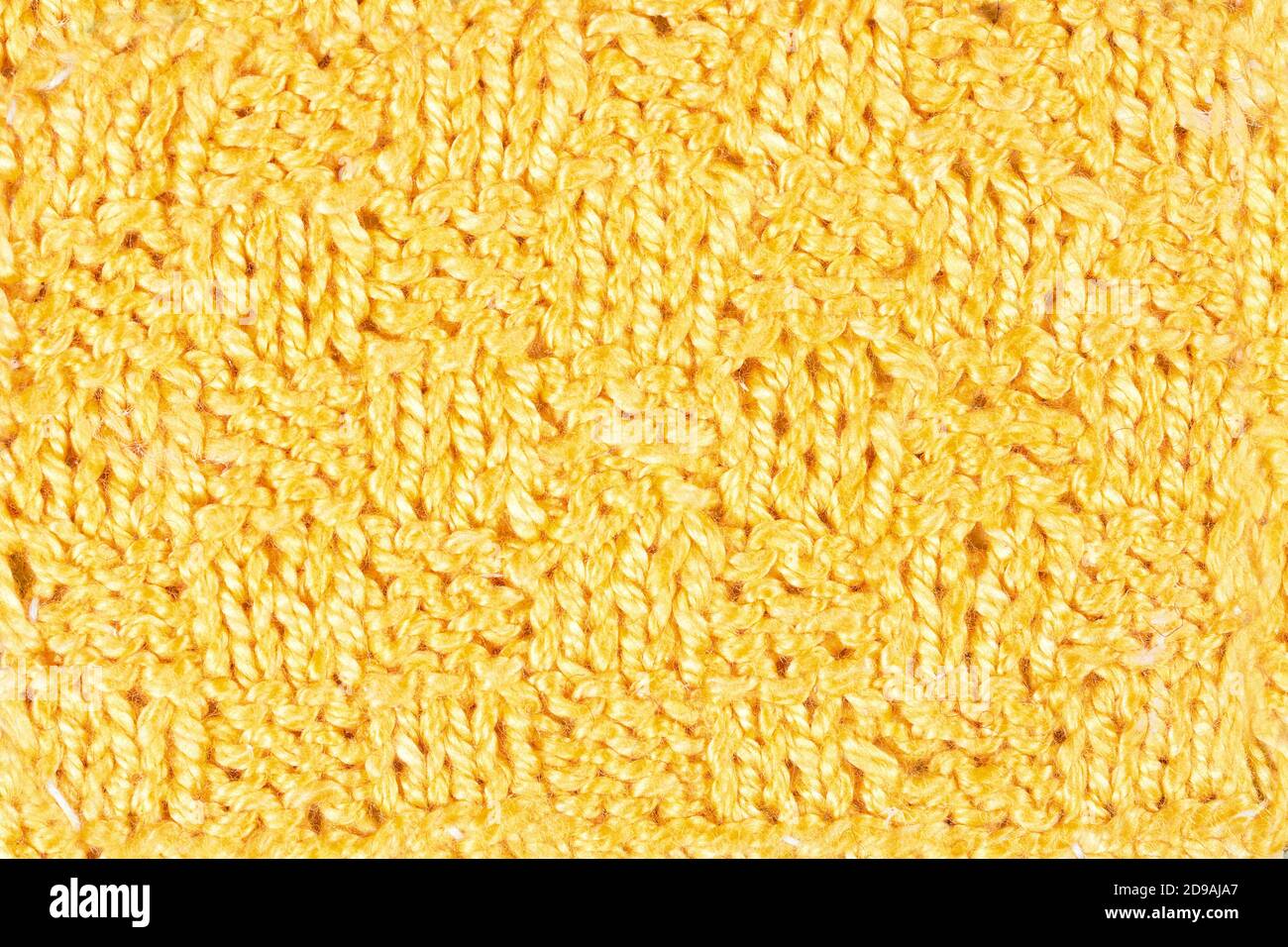 Fond jaune tricoté à la main. Motif vintage de tricot à la main rustique du milieu du siècle dernier. Jaune laine vintage gros plan an Banque D'Images