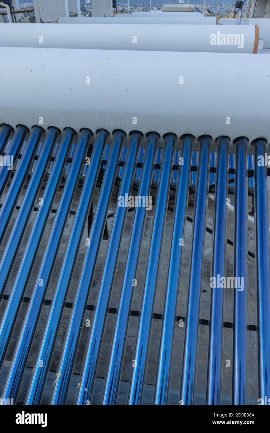 panneaux solaires et tubes installés pour le chauffage de l'eau sur le toit hauts de maisons et de bâtiments pour économiser l'énergie Banque D'Images