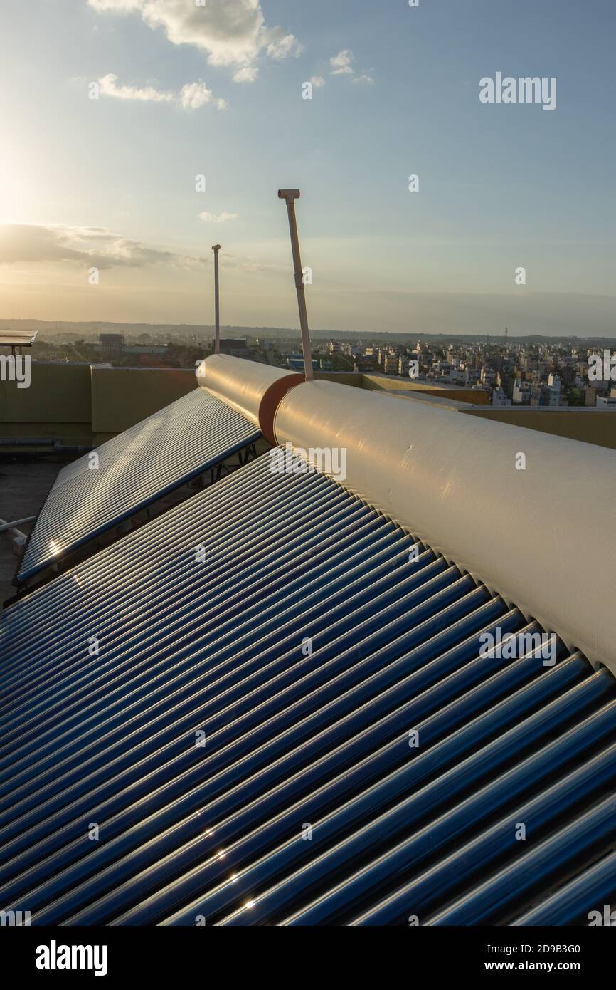 panneaux solaires et tubes installés sur le toit des maisons et des bâtiments pour économiser l'énergie Banque D'Images